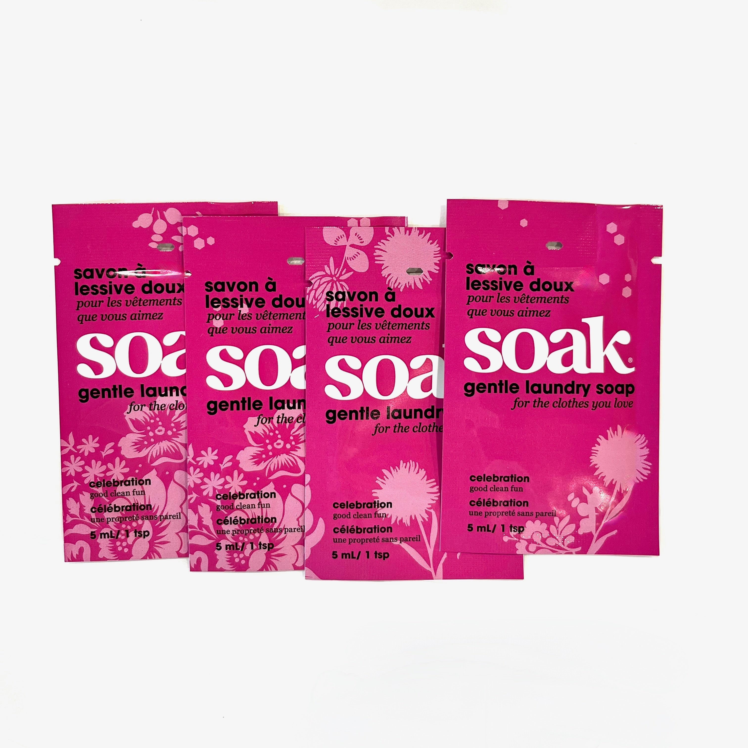 Four mini-size packets of Soak Celebration laundry detergent on a white background