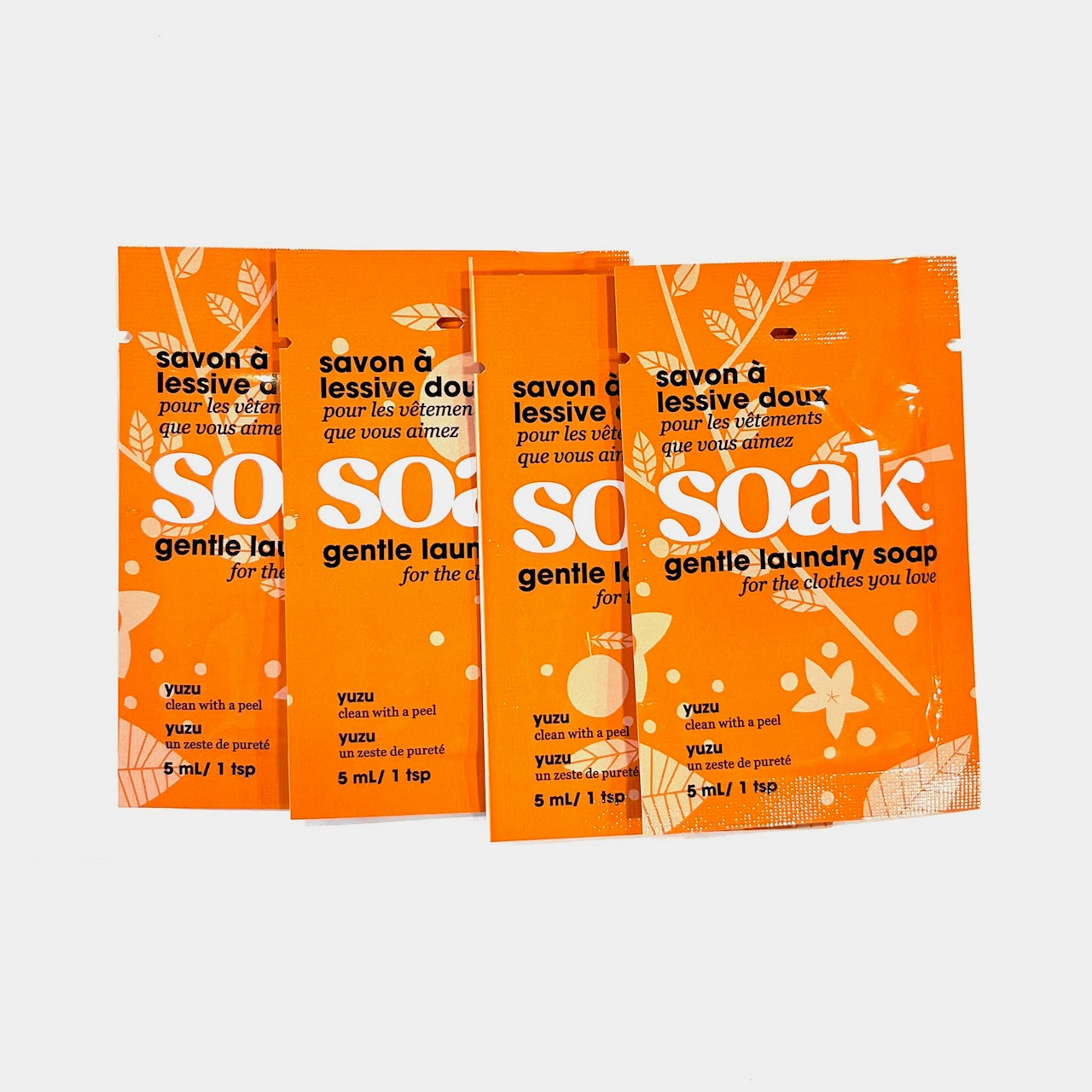 Four mini-size packets of Soak Yuzu gentle laundry soap on a white background